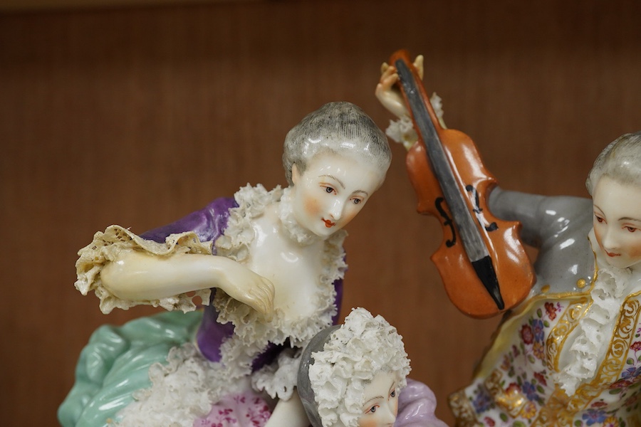 A large German porcelain group of ladies and a violinist, early 20th century, 23cm high